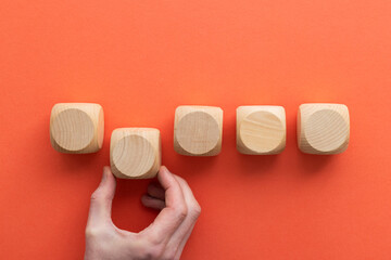 Hand choosing a wooden block from a set. Business choice concept
