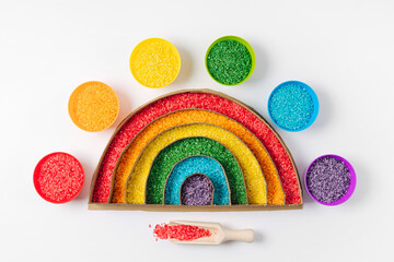 Rainbow filled with bright colored rice. Sensory bin for busy toddler.  Montessori material....