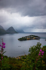 panorama of senja island, norway, overlooking the small island of husoy and its harbour; the famous norwegian fjords