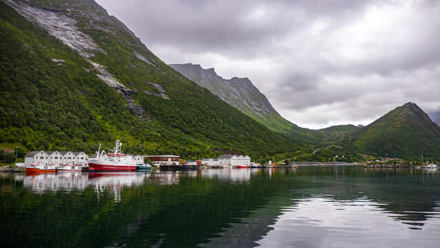 panorama of senja island, norway, overlooking the small island of husoy and its harbour; the famous norwegian fjords