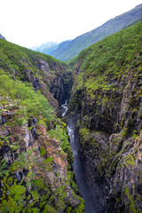 Fototapeta na wymiar huge canyon with a large waterfall in northern norway, sarafossen in lyngenfjord, northern norway landscape