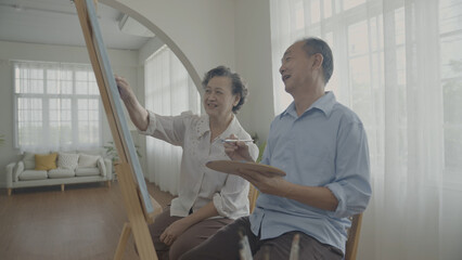 Obraz premium Artist concept of 4k Resolution. Asian families drawing together in the living room. Artist is creating work. Leisure activities and hobbies.