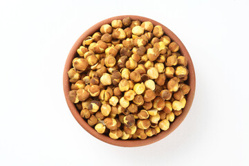 Roasted chickpeas in a terracotta bowl on a white background
