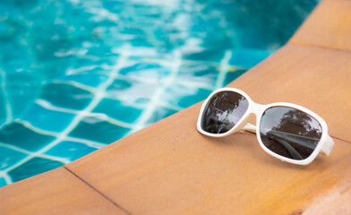Sun glasses near swimming pool,summer travel concept
