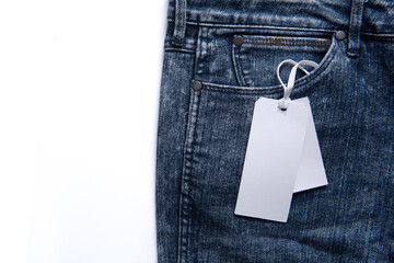 Label price tag mockup on blue jeans on white background