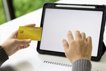 Close-up woman holding credit card using tablet, Online shopping concept.