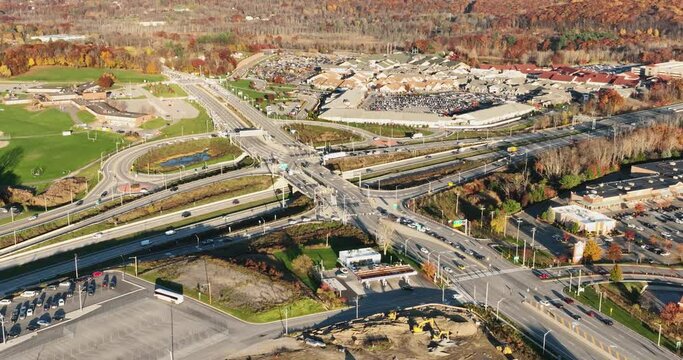 Aerial, drone, afternoon video of a diverging diamond interchange (DDI), located in Woodbury, NY, zooming out.