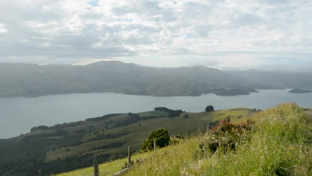 Beautiful landscape over the Akaroa Head surrounded by mountains on a windy day
