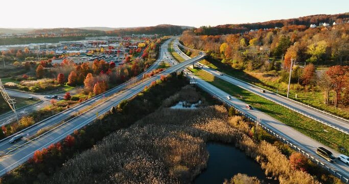 Afternoon aerial, drone, video of NY Route 17 just west of the diverging diamond interchange (DDI), located in Woodbury, NY, with a dolly move toward the subject.	