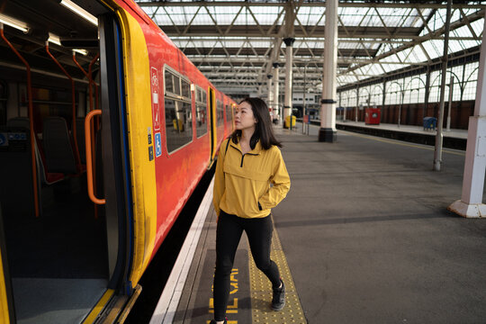 Asian female passenger entering train