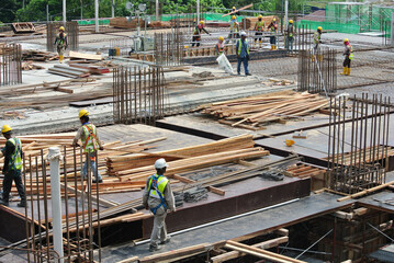 JOHOR, MALAYSIA -MAY 15, 2016: Construction site in progress at Johor, Malaysia during daytime. Workers busy with their task installing form work, reinforcement bar and other task.    