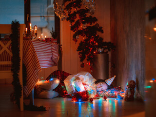 Peacefully sleeping woman covered with blanket under Christmas tree resting after New Year party
