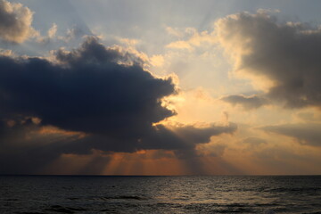 Fototapeta na wymiar The sun sets below the horizon on the Mediterranean Sea in northern Israel.