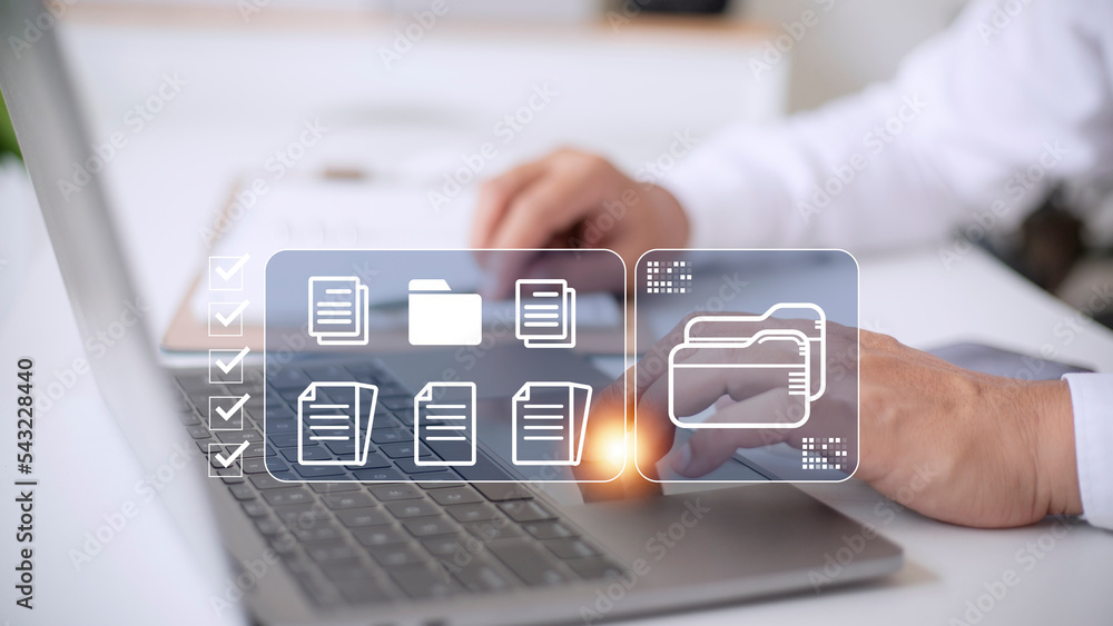 Poster document management system (dms) being setup by it consultant working on laptop computer in office. 