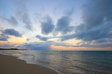 Calm ocean and beach on tropical sunrise
