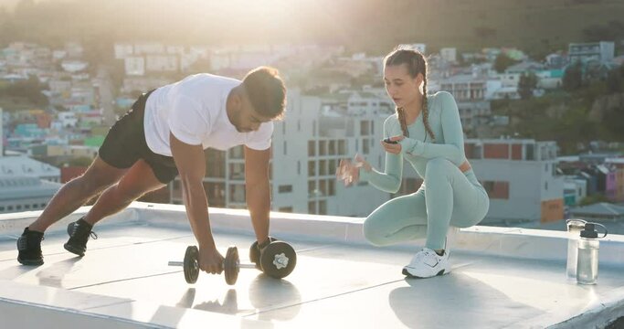Fitness, weights and couple doing a pushup workout for sports training in the city on a rooftop. Motivation, healthy and man athlete doing a strength exercise with his girlfriend coaching him in town