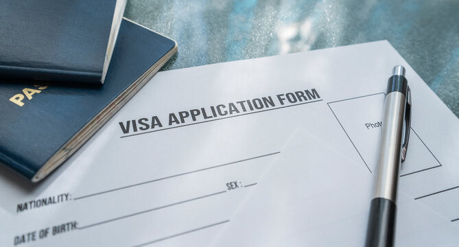 A visa application form and passorts on the table. 