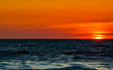 Fototapeta na wymiar Colorful golden sunset big wave and beach Puerto Escondido Mexico.