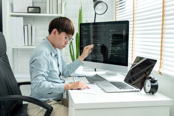 Male programmer is programming to develop program app and website of corporate while working to...
