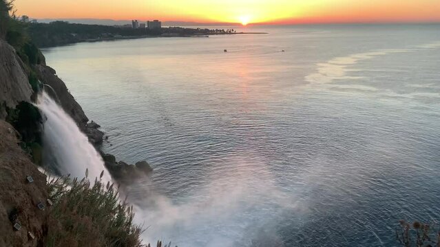 Duden waterfall in the Duden park on the Mediterranean coast in Antalya, Turkey. View of  seascape, beautiful sea and steep rock on a sunrise