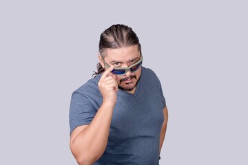 A man drop his sunglasses to show a glaring eye as if to warn someone. Reminding who is the boss....
