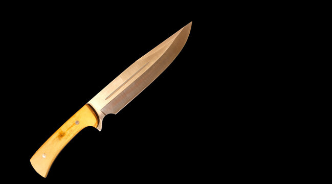 chef's knife with wooden handle on a black marble background