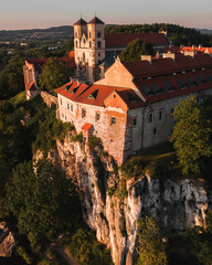 Benedictine Abbey in Tyniec is stunning monastery above the river. Historical church on rock with medieval look and mood. Drone footage of this chapel. Landscape of Poland rural countryside sunset.