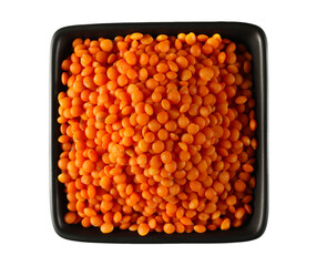 Red lentils uncooked pile in porcelain dish isolated on white, top view