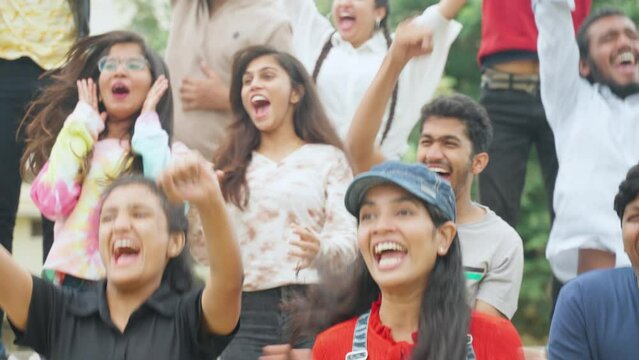 tensed girl excited and started celebrating with audience after win of match during interesting cricket match - concept of enjoyment, support and tournament