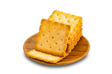 High angle view pile of dry sweet delicious square shape crackers in wooden plate isolated on white background with clipping path.