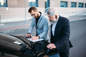 business people working outside office building