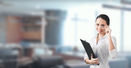 Happy business woman using clipboard at work