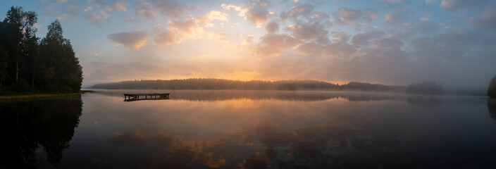 Calm sunrise in misty lake