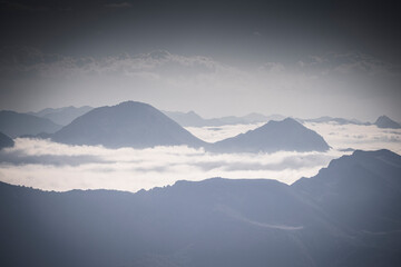 Fototapeta na wymiar rocky mountain ridges at sunset with fog