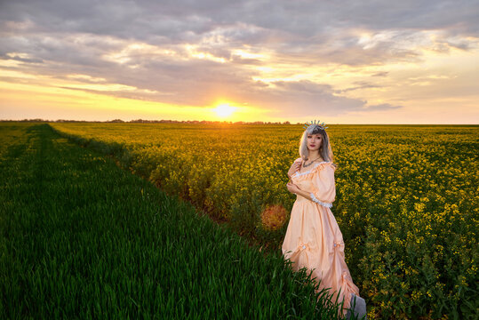 Girl in a dress in a yellow-green field
