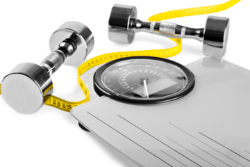 Healthy lifestyle fitness weight control concept. Closeup  dumbbells with measuring tape on  scales