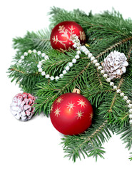 Christmas toys on fir tree branch , isolated on white