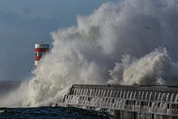 Fototapeta premium Storm at the river mouth beacon and pier