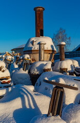 Old large water valves covered with snow in winter