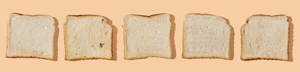 Collection of toast slices on orange pastel background