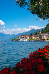 Spectacular view of Bellagio on Lake Como, Lombardy, Italy. Scenic landscape of the lake and Swiss Alps in the background on a sunny summer day. 