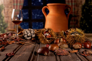 Autumn table with chestnuts, leaves and jeropiga.