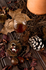 Autumn table with chestnuts, leaves and jeropiga.