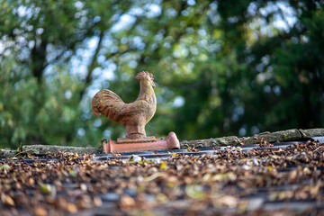 clay rooster on the roof of a traditional peasant house, central Croatia