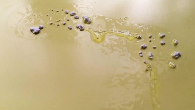 Chemical activation reaction of cyanoacrylate adhesive for plastic. The liquid glue instantly freezes on the surface.