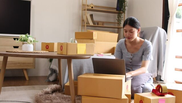 young businesswoman using laptop computer online chat with packaging box, Business online influencer on social media concept, Online Selling, Online Shopping to market.