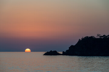 Sunset touching the ocean at Turkey beach