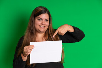 Young woman holding a empty white paper,   Green Background