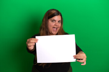 Young woman holding a empty white paper,   Green Background