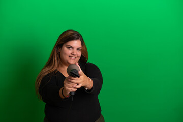 Yound woman with a hairdryer,   Green Background